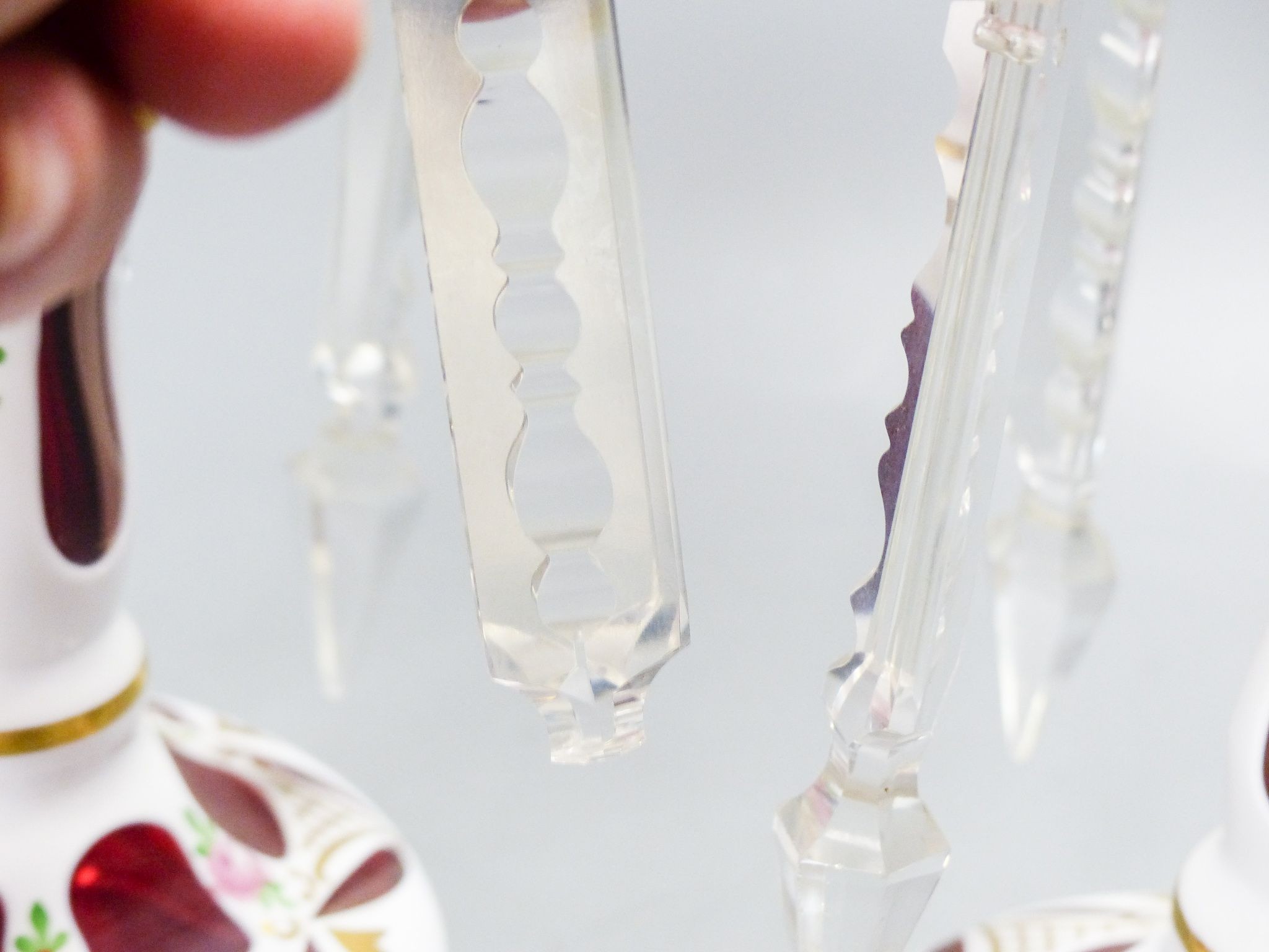 A pair of Bohemian style white and ruby overlaid glass table lustres, 20th century, 20.5 cm high